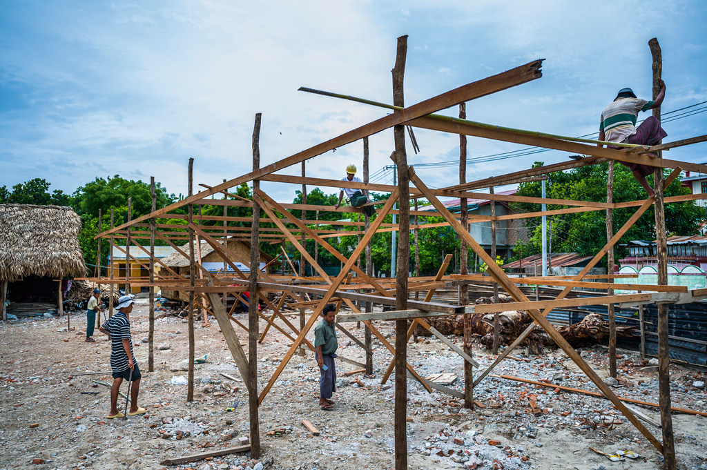 Workers constructing a temporary learning shelter for children in Myanmar's Sagaing region after a devastating earthquake in the region.
